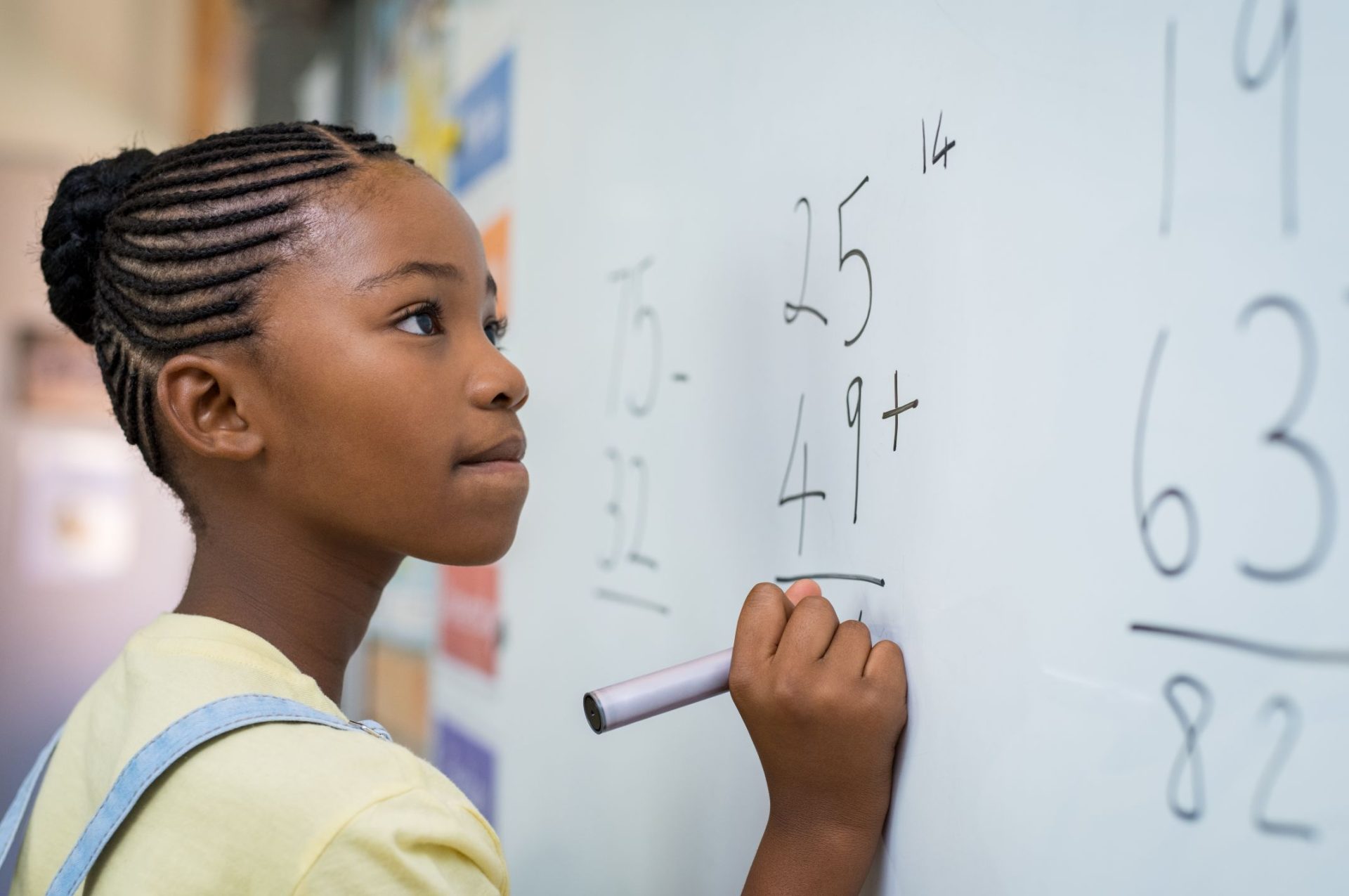 girl solving mathematical addition