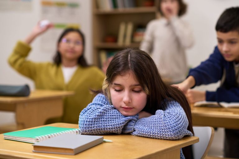 Sad Girl Resting at School with Classmates
