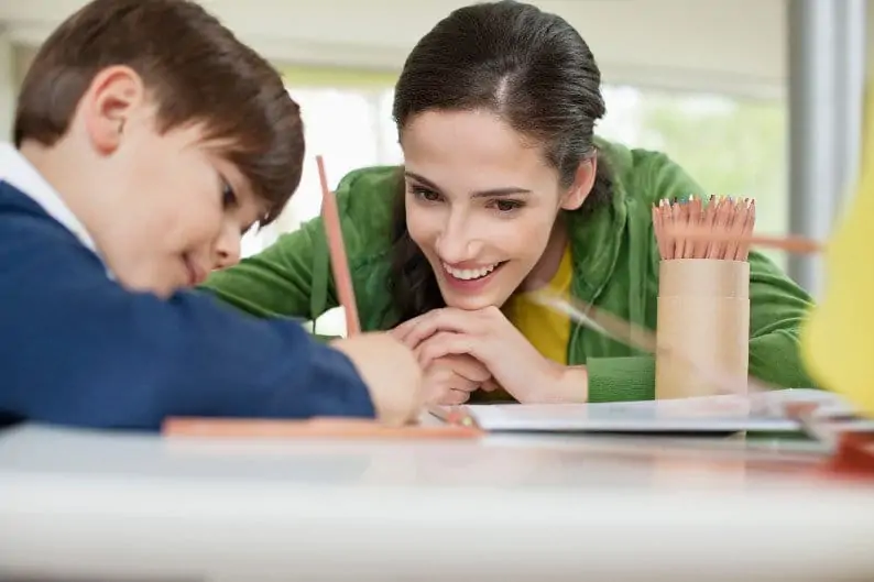 Understanding Physical Health Challenges | Tutor helping a young student with his studies