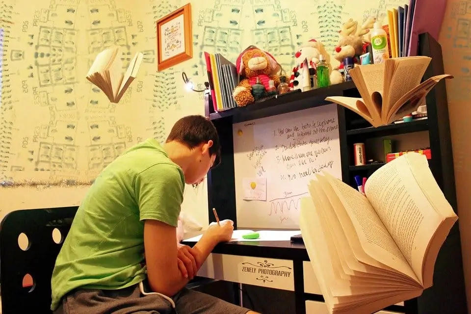 boy writing at desk with dyspraxia